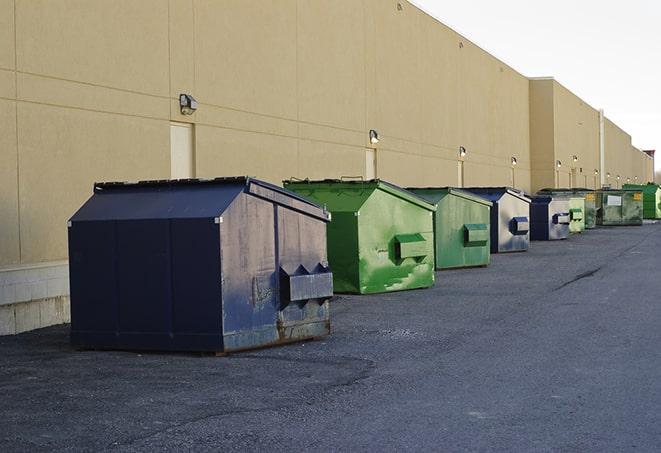 several large trash cans setup for proper construction site cleanup in Adair